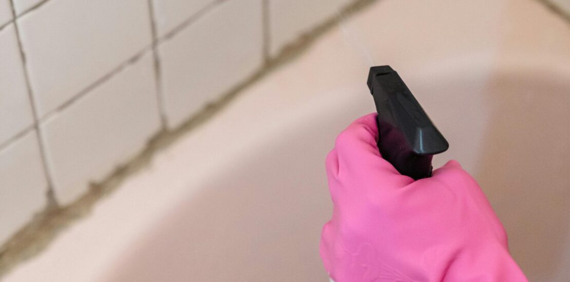 Cleaning bathroom grout with gloves - mold vs mildew removal